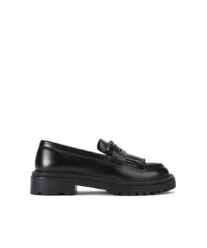 The KG Kurt Geiger Marty is a formal black slip-on loafer. There is a statement tassel detail across the toe with cut out strap. The sole is pumped up with tread detail.