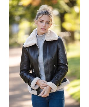 Stay warm and stylish with our Ladies Sheepskin Aviator Jacket, a timeless blend of luxury and comfort. Crafted from premium leather, this jacket is beautifully designed with a plush faux fur lining to provide extra warmth and a soft, cozy feel. The oversized faux fur collar and accents along the cuffs and hem add a touch of elegance and classic charm, perfect for chilly days and evenings. Equipped with a front zip closure and two practical zip pockets, this aviator jacket delivers both functionality and fashion. The adjustable buckle straps on the cuffs ensure a tailored fit, while the rich caramel hue makes it a versatile piece that pairs seamlessly with your winter wardrobe.
