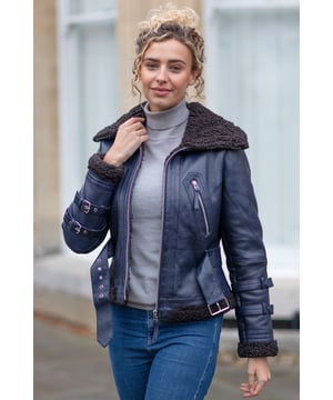 The Women's Aviator Leather Jacket combines luxury and functionality with a timeless aviator-inspired design, crafted from premium leather and lined with plush faux fur for exceptional comfort and durability. Featuring an oversized fur collar for warmth and style, a zip-up front closure, and an adjustable belted waist for a flattering silhouette, it ensures both practicality and elegance. Contemporary details such as buckle accents on the cuffs and multiple zippered pockets enhance its modern appeal, making it a versatile and stylish choice.