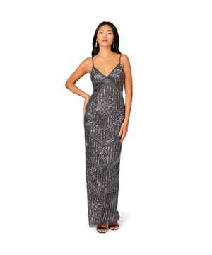 Fully beaded in a deep silver colour, this gorgeous full-length slip dress catches the light with every movement. Art deco-inspired sequin and beading placement highlights the deep v neck and defines the waist. Adjustable straps and a back zipper ensure the perfect fit. This exquisite sleeveless gown provides maximum sparkle while evoking opulent old world glamor.