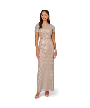 Elevated design brings this short sleeve sequin gown into the spotlight. This formal dress features a boat neckline, short sleeves, and a fitted silhouette. Crafted from luxe mesh that is fully lined, this evening gown shines throughout thanks to sequin grid beading. Tightly beaded sequins at the waist create a belted look and accentuate the figure. A v-back, hidden zipper closure, and a slit at the centre back of the skirt completes this black-tie gown. This short sleeve gown is a sparkling look when paired with nude heels and a metallic satin clutch.