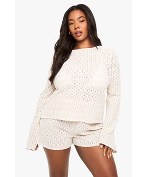 Textured zig zag knitted pattern for a distinctive beach-ready look         Flattering tie-front design with open back detail for a breezy feel         Wide bell sleeves adding a relaxed, bohemian touch         Inclusive plus sizing for comfortable, confidence-boosting fit         Coordinating shorts included for a complete beach ensemble
    
    This eye-catching knitted beach top combines style and comfort for your next sunshine getaway. The distinctive zig zag pattern creates visual interest while the tie-front detail accentuates your figure beautifully. The open back with tie fastening adds a flirty touch that's perfect for catching the sea breeze. Pair with the matching shorts for an effortlessly coordinated look by the pool, or style with denim cut-offs and sandals for beachside lunches. Add oversized sunglasses and a woven tote bag as seen on our model for the complete holiday aesthetic. This versatile set transitions seamlessly from lounging by the pool to casual evening strolls along the promenade. For cooler evenings, layer with a lightweight kimono and swap sandals for espadrilles to maintain that carefree summer vibe.
