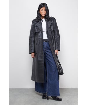Real leather construction for authentic texture and durability
        Classic double-breasted front with notched lapels
        Adjustable belted waist to create a flattering silhouette
        Full-length design with traditional storm flap detail
        Practical side pockets for everyday essentials
    
    This timeless leather trench coat from Warehouse combines iconic styling with contemporary edge. The double-breasted design and belted waist create a structured silhouette that can be cinched or worn loosely depending on your mood. Style with wide-leg denim and ankle boots for an effortlessly cool daytime look, or layer over a simple white tee and jeans for casual weekend outings. The versatile full-length cut works beautifully for family gatherings or coffee dates, whilst offering practical protection against the British weather. For a more refined ensemble, pair with tailored trousers and flat loafers. This investment piece will become a cornerstone of your wardrobe, adding a touch of confidence to any casual outfit whilst maintaining that distinctive Warehouse edge that sets you apart from the crowd.