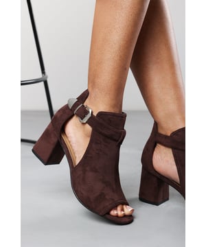 Elevate your look with our Lisa Block Heel Sandals, designed with an elegant open toe, cut-out sides, and a sleek side buckle. The mid-height block heel provides balance and comfort, making them perfect for all-day wear. Versatile and stylish, these sandals pair effortlessly with both casual and dressy outfits. Key Features: • Material: High-quality Suede upper with rubber sole • Design: Open toe and open side silhouette with side buckle detail • Closure: Adjustable side buckle for a secure fit