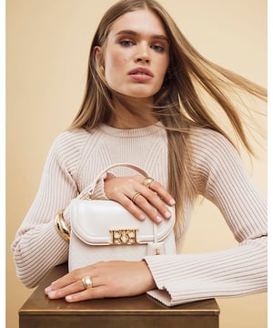 ​Patent, RI monogram print, Grab handle, Detachable cross body strap, Charm detail, Gold branding, Interior zipped compartment, Front flap closure, Strap length: 60cm, H: 16cm x W: 24cm x D: 10cm