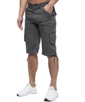Enzo Mens Cargo Combat Jeans. 7 Pocket Design Including Single Coin Pocket. 2 Front Slash Pockets with Extra Fabric Stitching Detail. 2 Side Cargo Pockets, 2 Back Bellow Pockets with Velcro Fastening Flap. Extra Stitching Details to all Pockets. Adjustable Drawstring to the Hems. Zip Fly Fastening. Premium Quality Fabric Ideal for Casual and Heavy Duty Work Wear.