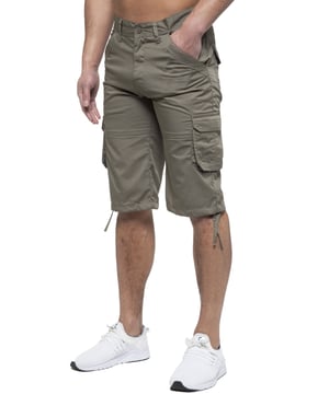 Enzo Mens Cargo Combat Jeans. 7 Pocket Design Including Single Coin Pocket. 2 Front Slash Pockets with Extra Fabric Stitching Detail. 2 Side Cargo Pockets, 2 Back Bellow Pockets with Velcro Fastening Flap. Extra Stitching Details to all Pockets. Adjustable Drawstring to the Hems. Zip Fly Fastening. Premium Quality Fabric Ideal for Casual and Heavy Duty Work Wear.