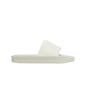 Y-3 Water Slides in off white.Handcrafted details accentuate the minimalist design of the Y-3 Water Slides. The textured PU footbed is crafted with intentional irregularities on top. The outsole nods to the famed adidas Adilette slides and gets finished with Yohji's signature on the bottom. Hand-stitched thread attaches the smooth polyurethane upper to the cushioned footbed.- Minimalist Y-3 slides with surprising texture.- Slip-on.- Polyurethane upper.- Synthetic suede backing on upper.- Polyurethane footbed.- Y-3 logo.- Regular fit.- Ref: IG4043