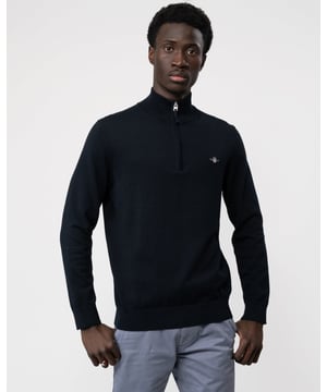 This regular fit cotton sweater combines style and comfort effortlessly. With its half-zip collar, ribbed detailing, and a GANT shield graphic embroidered at the chest, it's a classic addition to your wardrobe. Perfect for staying cozy and looking sharp, whether you're dressing up or keeping it casual.

Regular fit
Half-zip collar
Ribbed neck, hem and cuffs
GANT graphic embroidered at chest

 100% Cotton

 
8030564

 
 