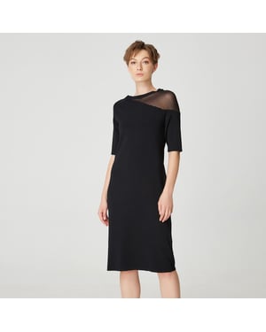 Minimalistisk jerseyklänning med asymmetrisk skärning