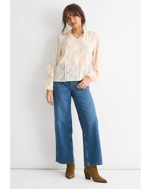 Långärmad blus med blommor i krämfärgad jacquard