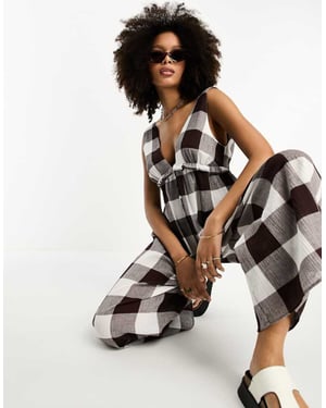 ASOS DESIGN tiered crinkle frill jumpsuit in brown gingham