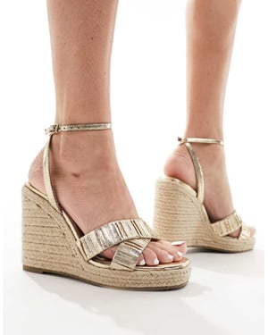 ASOS DESIGN – Tiptoe – Guldfärgade espadriller med kilklack och korsade remmar