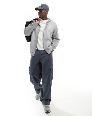 ASOS DESIGN unisex oversized zip hoodie i tvättad ljusblå