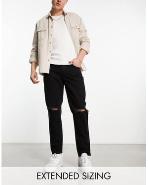 ASOS DESIGN tapered fit jeans i svart tvätt med knäsprickor - SVART