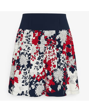 Geplooide A-lijn rok met bloemenprint en contrasterende marineblauwe tailleband.