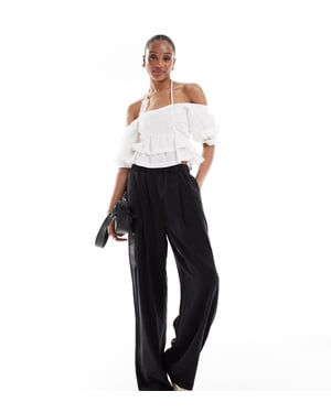 ASOS DESIGN Lång premium avslappnad byxa med veckdetalj i tvättad svart