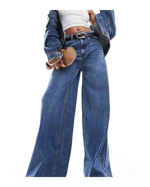 ASOS DESIGN Lång hög midja vida jeans i mellanblå