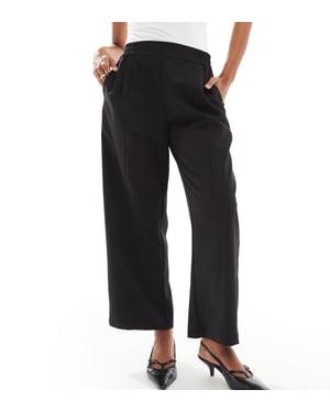 ASOS DESIGN Petite barrel leg pull on tailored trouser in black
