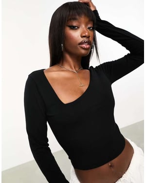 ASOS DESIGN cotton asymmetric scooped neck long sleeved crop top in black