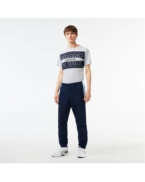 Men's Lacoste Solid Patterned Slim Joggers in Navy Blue/White