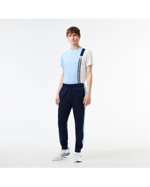 Men's Lacoste Vertical Logo Color Block Slim Cut Track Pants in Navy Blue