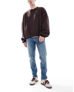 ASOS DESIGN skinnyjeans med grön ton i mörkblå tvätt