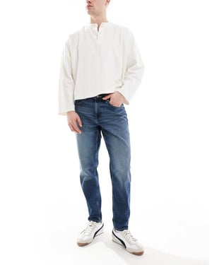 ASOS DESIGN tapered jeans i mörk tvätt