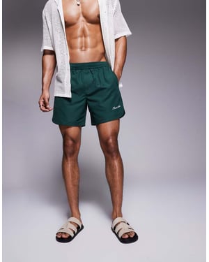 ASOS DESIGN swim shorts in mid length with embroidery in green