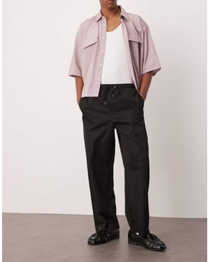 ASOS DESIGN pull on smart wide leg trousers with hem poppers in black