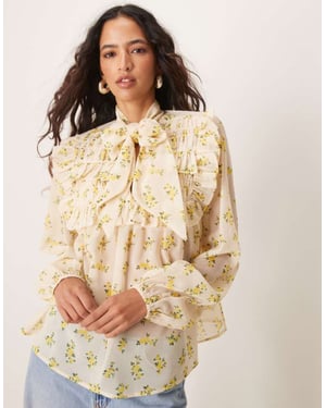 ASOS DESIGN tie neck shirred frill detail top in floral print