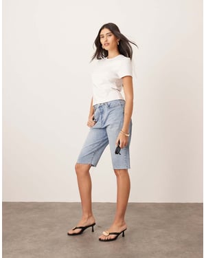 ARRANGE Cleo denim longline short with raw hem in mid wash blue