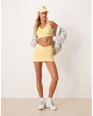 4505 wrap waist tennis skirt with under short and phone pocket in pale yellow
