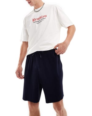 ASOS DESIGN oversized plisserade shorts i marinblått
