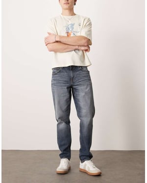 ASOS DESIGN stretch tapered jeans i medtvättad blå