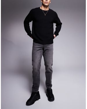 ASOS DESIGN tapered jeans med vintage ton i tvättad svart