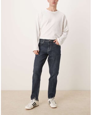 ASOS DESIGN stretch tapered jeans i mörk tvätt blå