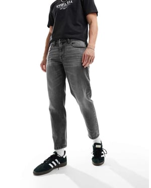 ASOS DESIGN tapered fit jeans i tvättad svart - SVART