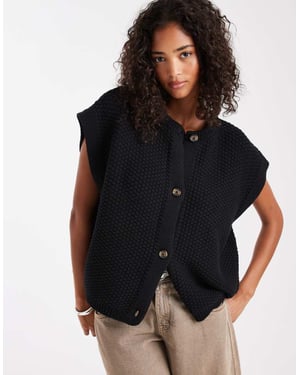 ASOS DESIGN boxy knitted stitch waistcoat with button detail in black