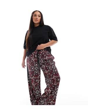 ASOS DESIGN Curve pull on trousers with contrast panel in dark cherry bandada print