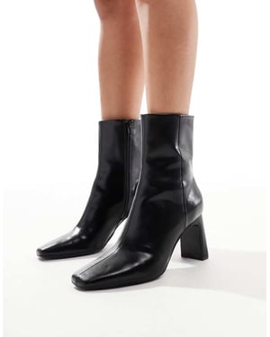 ASOS DESIGN Reach set back mid heel boots in black