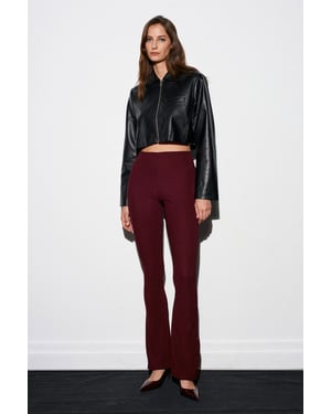 Hoog-getailleerde flare leggings met knoopdetail