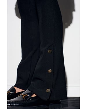 Hoog-getailleerde flare leggings met knoopdetail