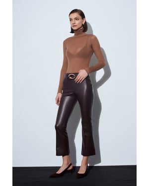 Högmidjade leggings i konstläder med utsvängd ben