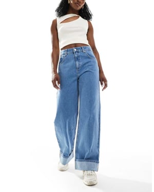 ASOS DESIGN loose jean with deep turn up cuff in clean mid blue