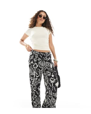 Vero Moda Petite high waist wide leg plisse trouser in tropical conversational print