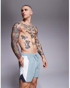 ASOS DESIGN swim shorts in short length with side vent cut and sew in blue