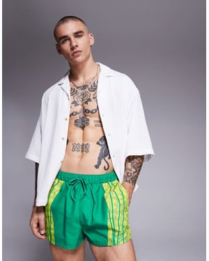 ASOS DESIGN swim shorts in super short length with placement animal print in green