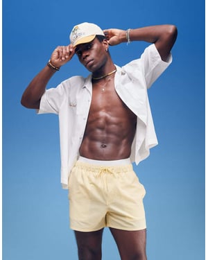 ASOS DESIGN seersucker swim shorts in short length in yellow
