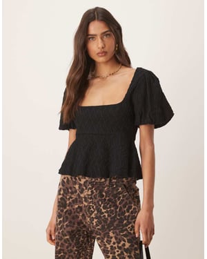 Gina Tricot vågig texturerad jersey med puffärmar och peplumkjol i svart